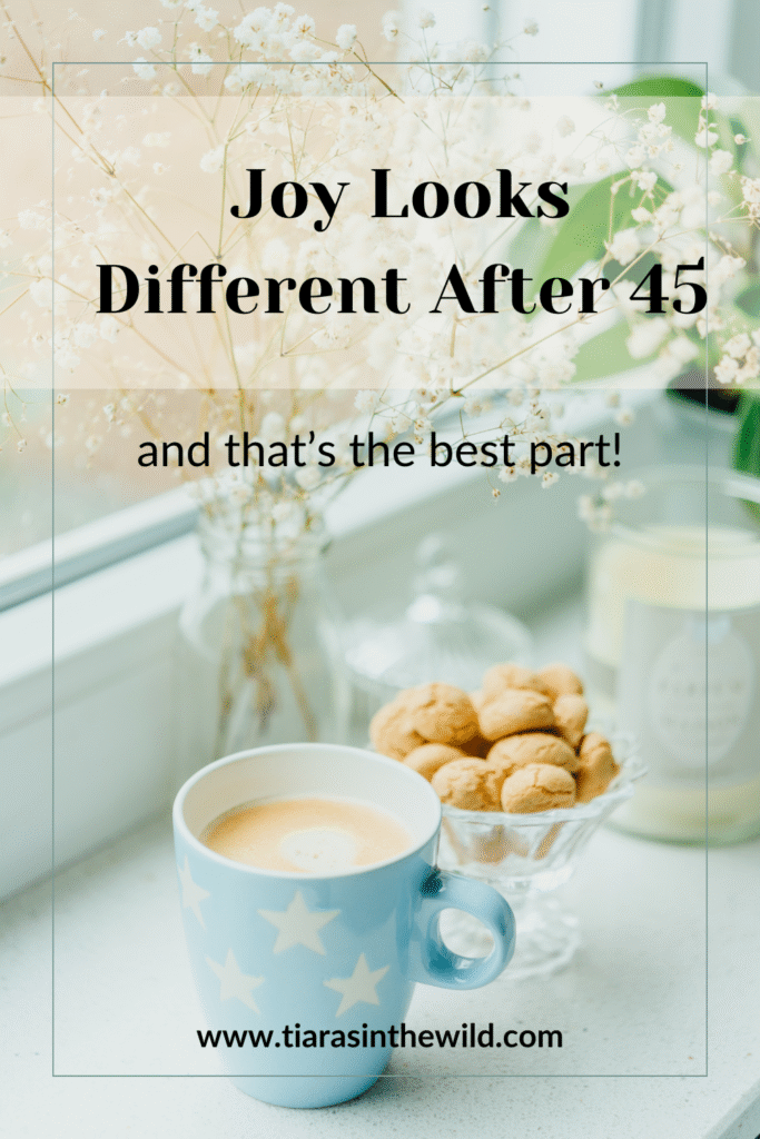 Image with text overlay that reads ‘Joy Looks Different After 45—and That’s the Best Part’ in playful, elegant fonts. Background includes a cup of tea, cookies and flowers, to evoke whimsy, warmth, and self-expression.