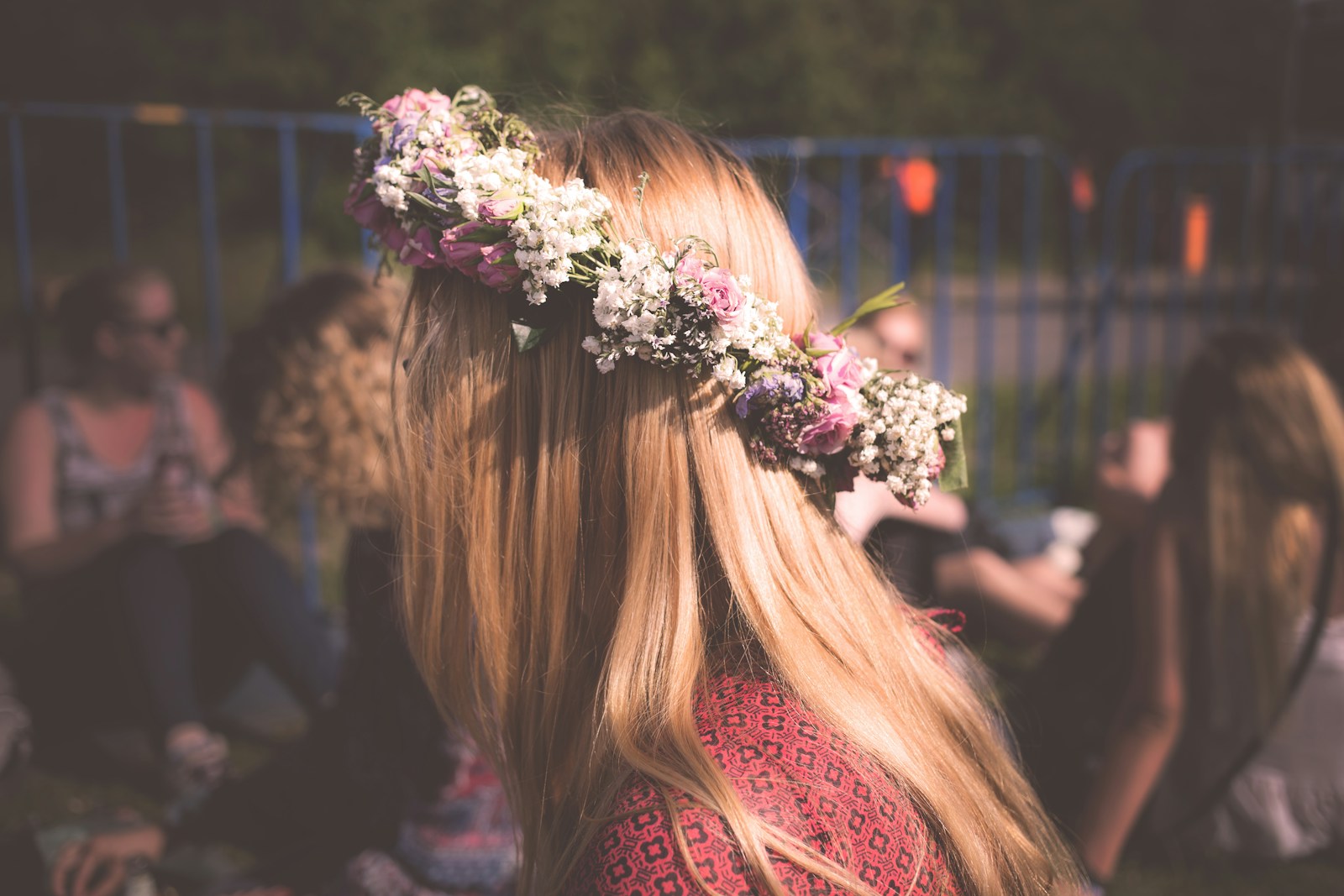 Wearing a whimsical flower crown for joyful self-expression.