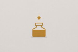 A warm-gold ink bottle with a small rising spark centered on a warm fog-gray background with a faint shadow.